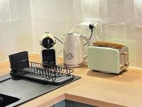a kitchen counter with a toaster a toaster and a toaster at Tropical Duplex : Bord de mer + Piscine in Frontignan