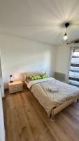 a bedroom with a bed and a wooden floor at Sublime studio en hypercentre avec parking privé 8 in Mulhouse