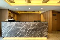 a marble counter in a lobby with wooden walls at Dafong Hotel in Zhongzheng