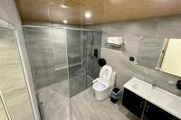 a bathroom with a shower and a toilet and a sink at Dafong Hotel in Zhongzheng