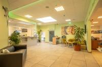 an office lobby with a couch and tables and chairs at Hotel B3 GmbH in Mauthausen