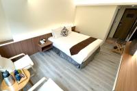 a hotel room with a bed in a room at Dafong Hotel in Zhongzheng