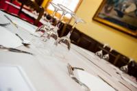 a table with wine glasses and forks on it at HOSTAL LAS PALOMAS in Lucena