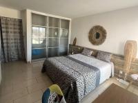 a bedroom with a bed and a large window at Superbe Appartement Vue Mer T3 70m2 in Mauguio