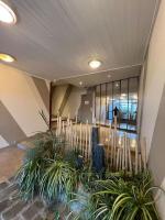 a lobby with some plants in a building at Superbe Appartement Vue Mer T3 70m2 in Mauguio