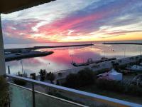 a view of a marina at sunset from a balcony at Superbe Appartement Vue Mer T3 70m2 in Mauguio