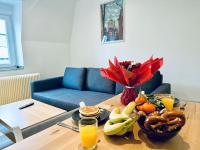 a table with a bowl of food and fruit on it at #Herbie2 - Appartement Mulhouse - Charme &amp; Confort in Mulhouse
