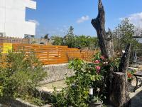 a wooden fence with some plants and flowers at 寧靜的家14人Villa獨立設施包棟戲水池烤肉區麻將廚房私人停車場 in Hengchun South Gate