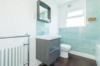 a bathroom with a sink and a toilet at Shell Cottage in Whitstable