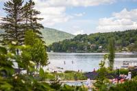 a view of a lake with people swimming in it at Entourage sur-le-Lac in Lac-Beauport