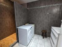 a bathroom with a washing machine and a sink at Gîte Cherves-Richemont, 3 pièces, 5 personnes - FR-1-653-205 in Cherves-de-Cognac