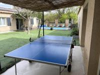 a blue ping pong table in a yard at Villa 200m2, 3 suites, patio avec salle jeux, 1 piscine CHAUFFE DE DEBUT AVRIL A FIN OCTOBRE in Maruéjols