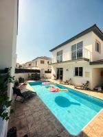 a swimming pool in front of a house at Athena Villa in Larnaka