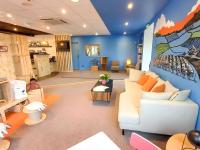 a living room with a white couch and a blue wall at greet Hotel Belleville en Beaujolais A6 in Belleville-sur-Saône