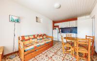 a room with a table and a bed and a kitchen at Lovely Home In Saint-savinien With Outdoor Swimming Pool in Saint-Savinien