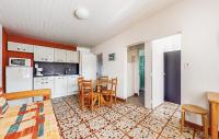 a kitchen and dining room with a table and chairs at Lovely Home In Saint-savinien With Outdoor Swimming Pool in Saint-Savinien