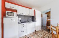 a kitchen with a white refrigerator and a microwave at Lovely Home In Saint-savinien With Outdoor Swimming Pool in Saint-Savinien