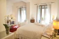 A bed or beds in a room at Milano Suites