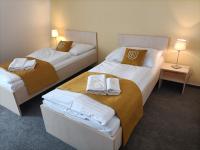 Łóżko lub łóżka w pokoju w obiekcie Hotel Eminent