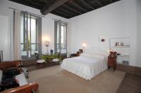 A bed or beds in a room at Milano Suites