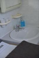 a bathroom with a white sink and a mirror at Le Cottage de la Baie - vue mer en Baie de Somme in Woignarue