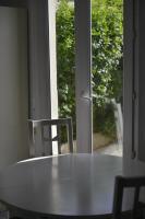 a table and two chairs in front of a window at Le Cottage de la Baie - vue mer en Baie de Somme in Woignarue