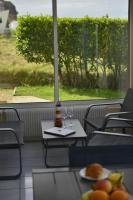 a table with two glasses and a plate of food at Le Cottage de la Baie - vue mer en Baie de Somme in Woignarue