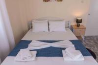 Posteľ alebo postele v izbe v ubytovaní Greekhome Seaside Apartment