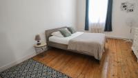 a bedroom with a bed and a wooden floor at Residence Pasteur Angouleme in Angoulême