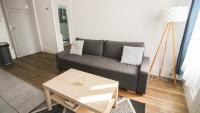 a living room with a couch and a coffee table at Residence Pasteur Angouleme in Angoulême