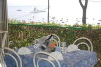 a blue table and chairs with a view of the ocean at Camping Villaggio Nettuno in Nerano