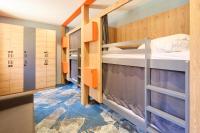 a small room with two bunk beds in it at Hotel Base Camp Lodge - Albertville in Albertville