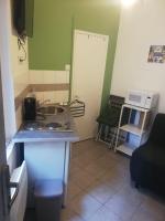 a small kitchen with a sink and a stove at Le mini Longchamp in Marseille