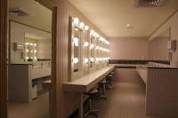 a bathroom with a row of sinks and mirrors at Hey Bear Capsule Hotel in Taipei