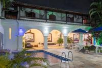 a house with a swimming pool and a patio at Pousada Boulevard in Cabo Frio
