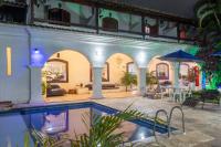 a house with a swimming pool and a patio at Pousada Boulevard in Cabo Frio
