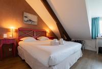a bedroom with a large white bed with a red headboard at Best Western Hotel De La Plage Saint Marc sur Mer in Saint-Nazaire