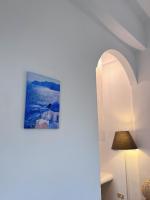 a room with a lamp and a picture on the wall at Greek Frontier Villa in Magong