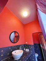 an orange bathroom with a sink and a mirror at Greek Frontier Villa in Magong