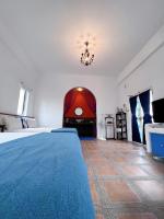 a bedroom with a large bed and a chandelier at Greek Frontier Villa in Magong