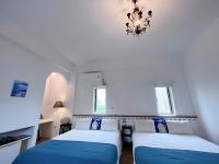 a bedroom with two beds and a chandelier at Greek Frontier Villa in Magong