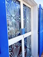 a door with a gate withpainted glass at Greek Frontier Villa in Magong