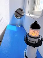 a lamp on a blue table with a mirror at Greek Frontier Villa in Magong