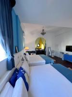 a hotel room with two beds and a tv at Greek Frontier Villa in Magong