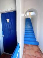 a hallway with blue stairs and a blue door at Greek Frontier Villa in Magong