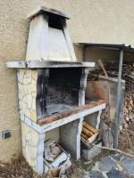 a brick oven sitting next to a building at Chalet Le Parc de Latour, au pied de la montagne in Latour-de-Carol
