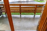 a wooden bench sitting inside of a porch at Résidence Le Parc Des Airelles - 2 Pièces pour 4 Personnes 454 in Les Orres