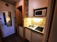 a small kitchen with a sink and a microwave at Résidence Chaviere - Studio pour 2 Personnes 034 in Les Menuires