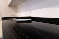 a kitchen with a black and white stove top oven at We Love Paris - Private Apartment in Vitry-sur-Seine