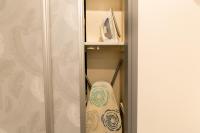 a surfboard is sitting on a shelf in a closet at We Love Paris - Private Apartment in Vitry-sur-Seine